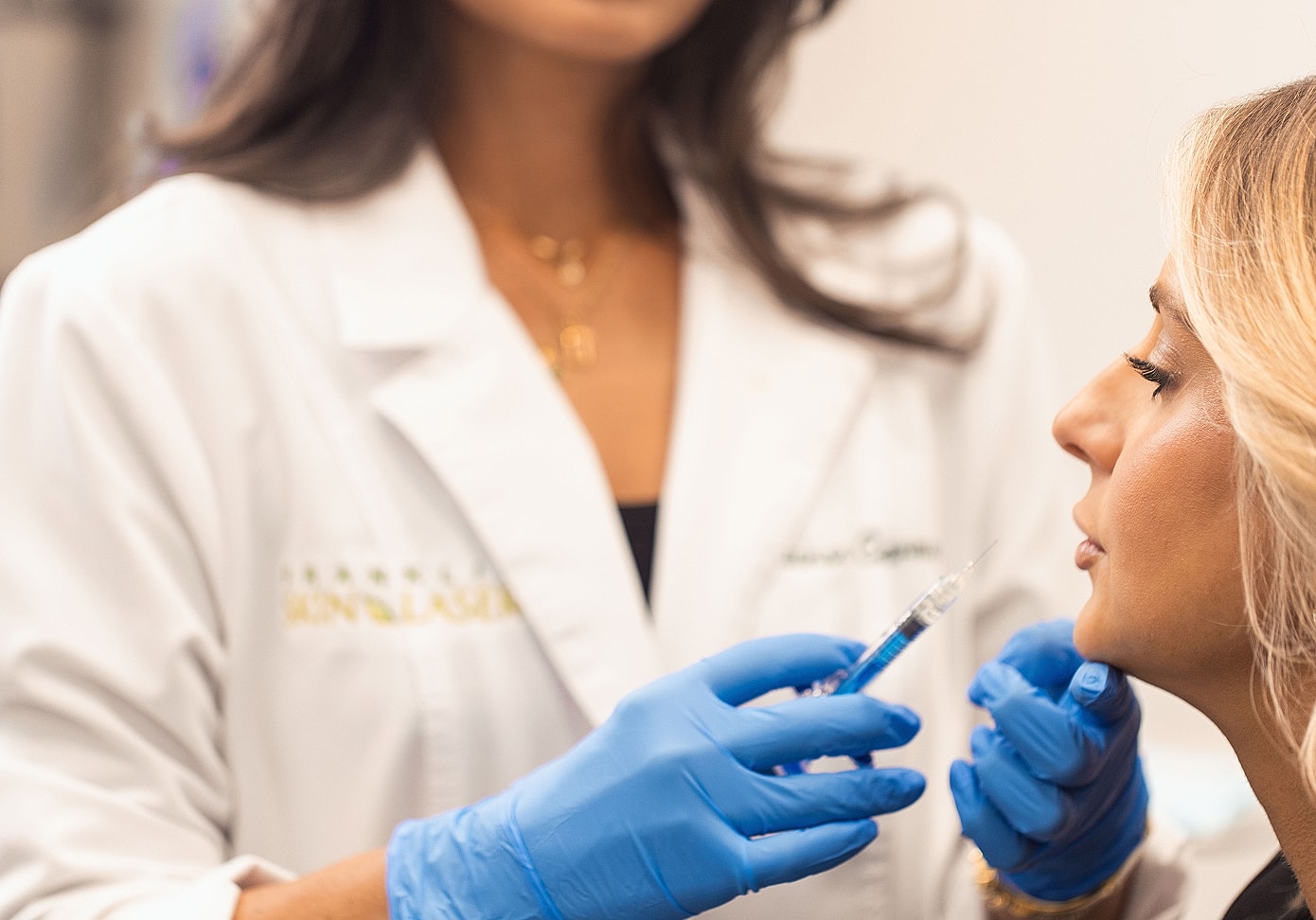 Woman receiving cosmetic injection in a clinic.