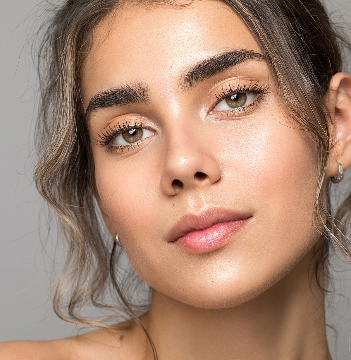 Close-up of a woman’s face with natural makeup.