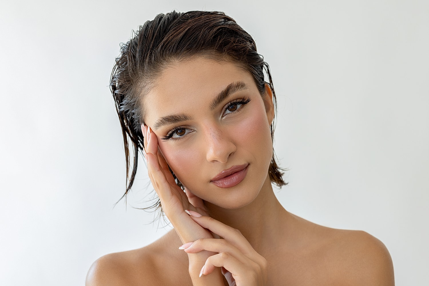 Model with natural makeup against a light background.