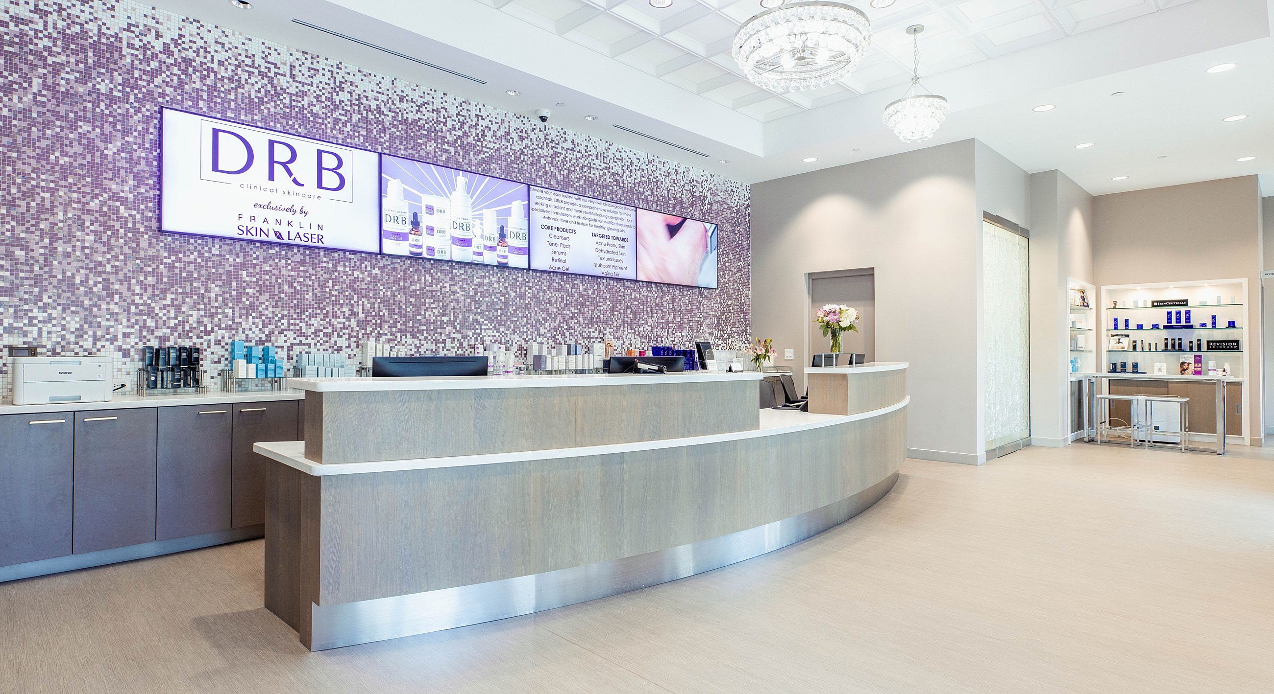 Modern skincare clinic reception area with products.