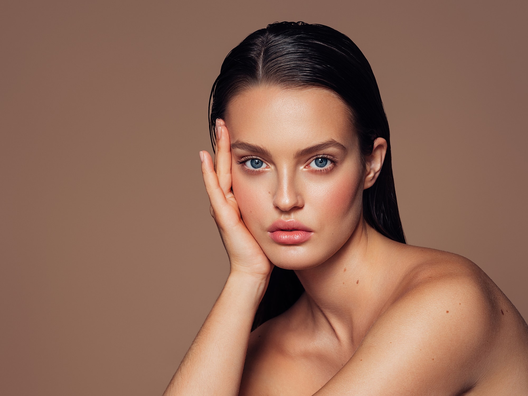 Beautiful woman with striking blue eyes and flawless skin