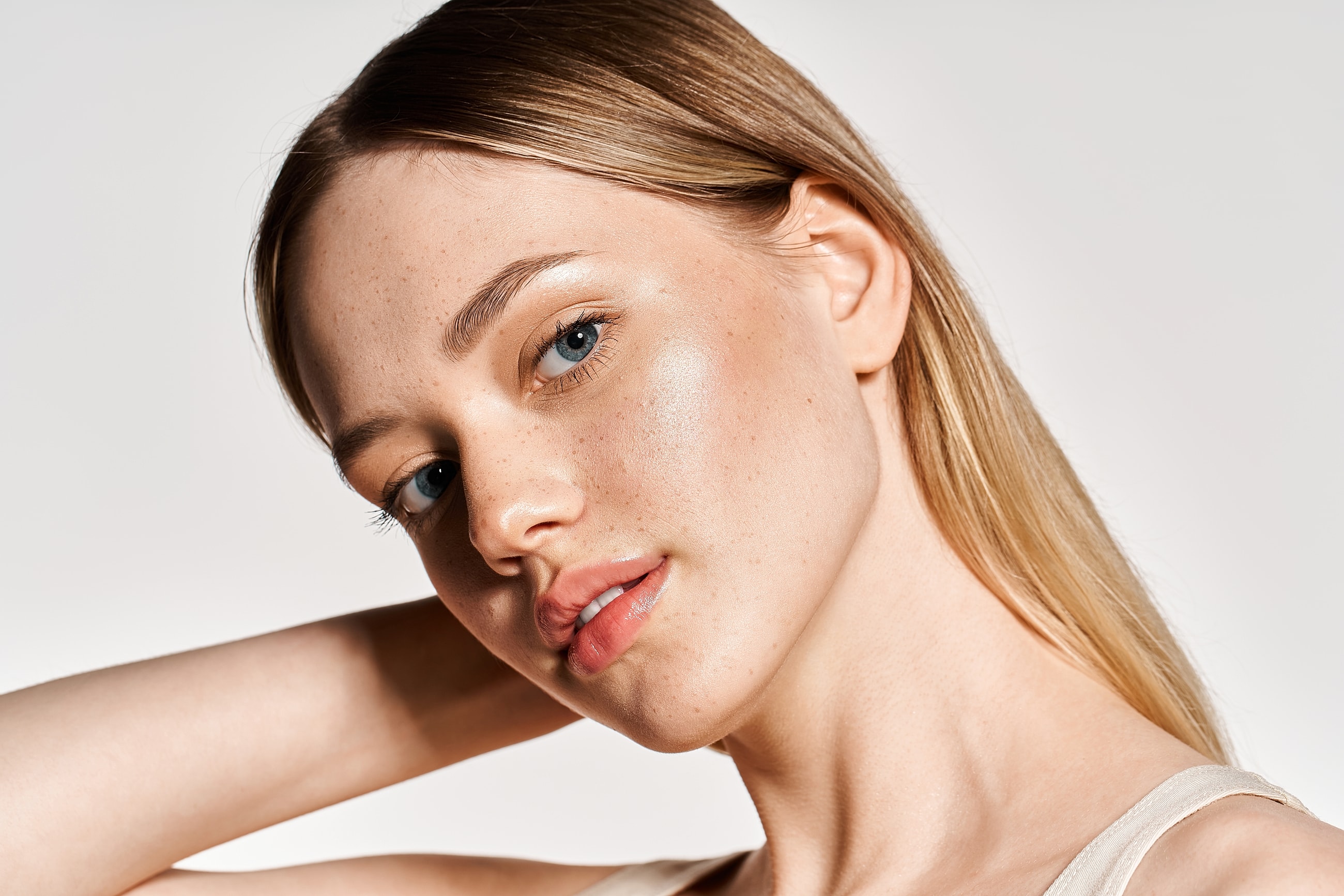 Close-up of a young woman with freckles.